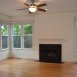 HUGE family room has a wood burning fireplace, ceiling fan, wood floors & great windows!