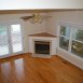 Family room has wood floors, fireplace, ceiling fan and door to the rear deck.