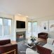 Awesome family room with fireplace & walls of windows!