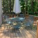 Deck overlooks woods and common area.
