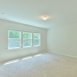 Primary bedroom is BIG & has a wall of windows, ensuite bath & WIC.